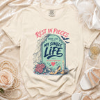 Cream t-shirt graphic with tombstone reading "Rest in Pieces Here Lies My Single Life She Had a Good Run".