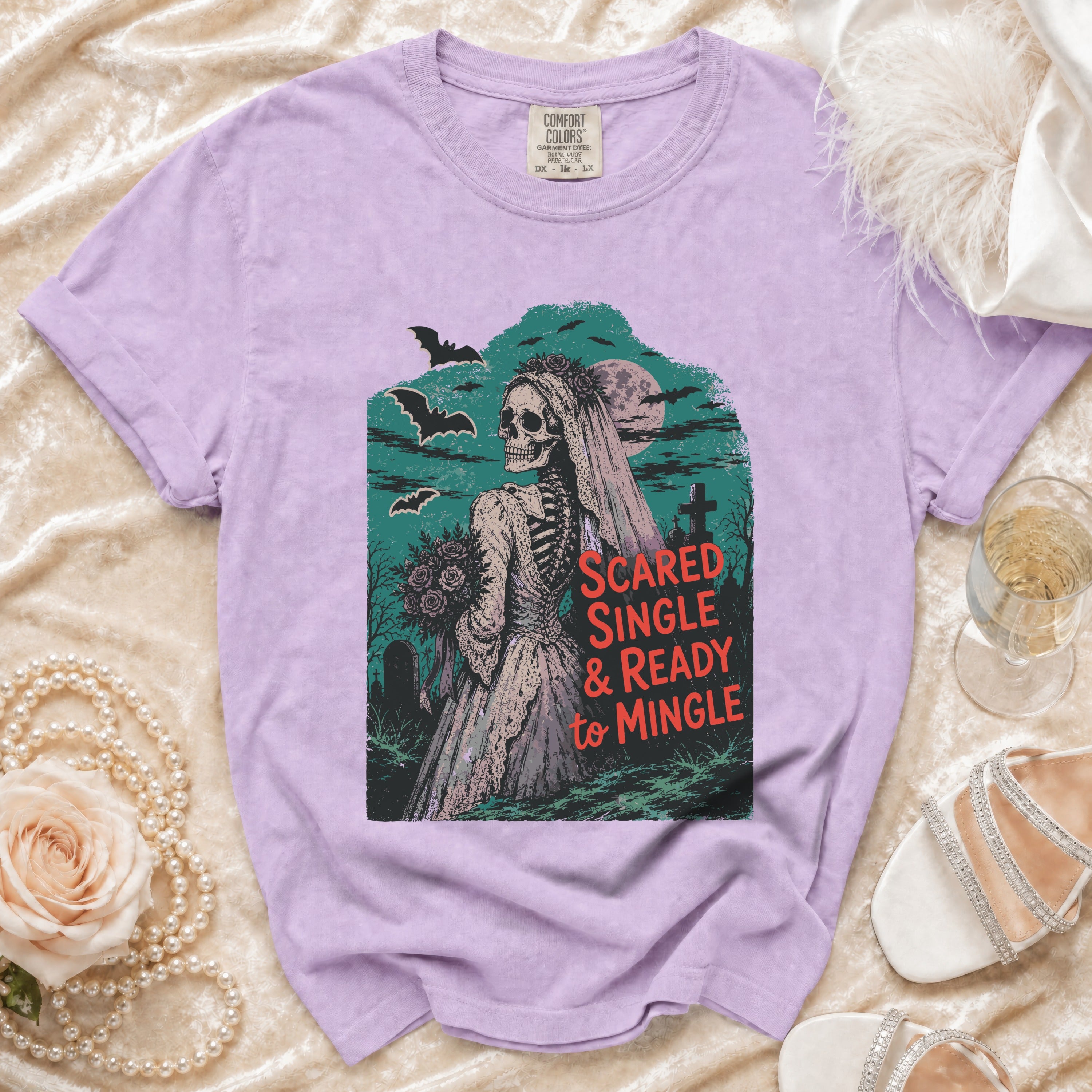 Purple t-shirt with skeleton bride graphic and text "SCARED SINGLE & READY to MINGLE".