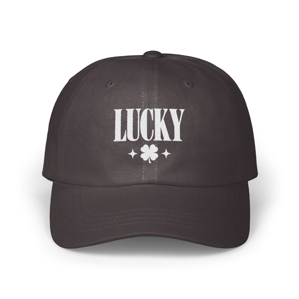A dark grey baseball cap with white embroidered text reading LUCKY above a four-leaf clover.