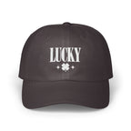 A dark grey baseball cap with white embroidered text reading LUCKY above a four-leaf clover.