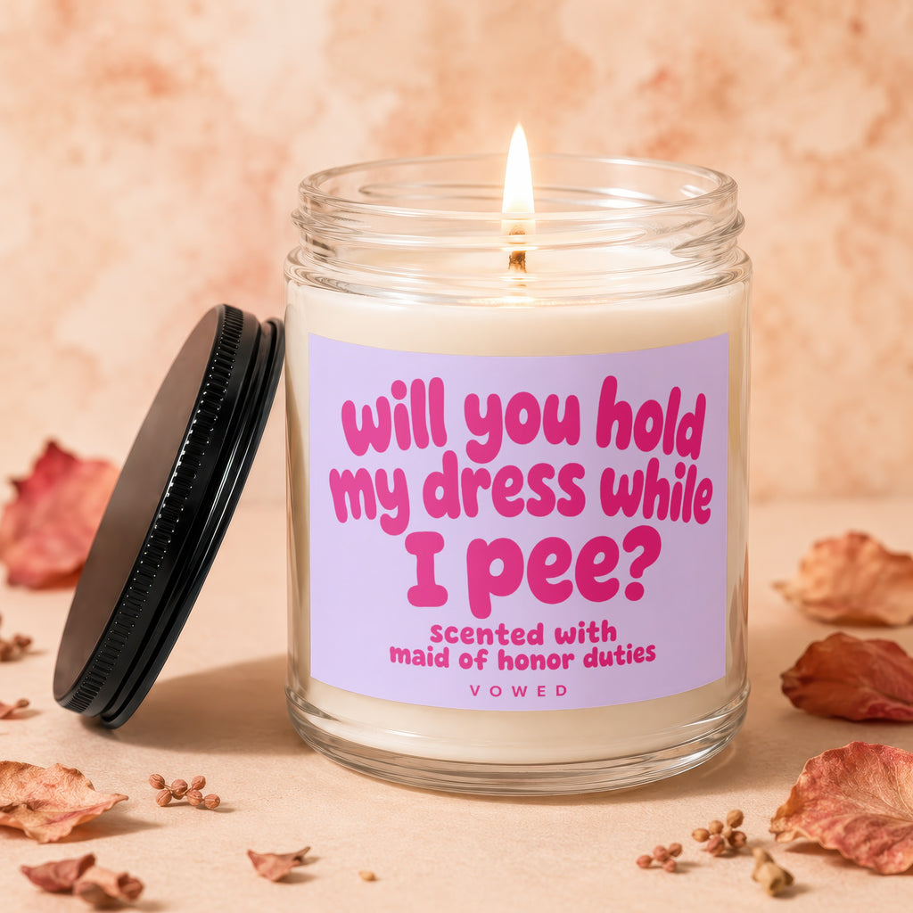 Candle with text: "will you hold my dress while I pee?"