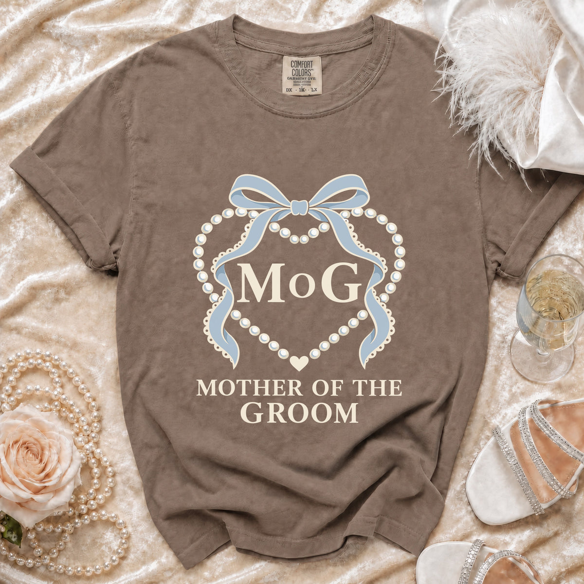 Brown t-shirt with "MOG MOTHER OF THE GROOM" text and pearl heart design.
