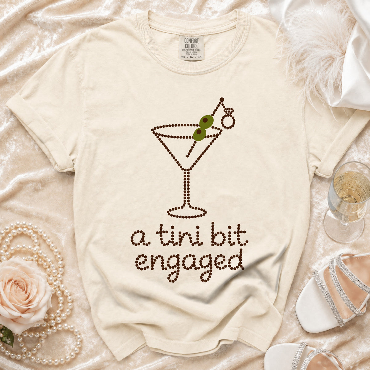 T-shirt with a martini glass design and text "a tini bit engaged".