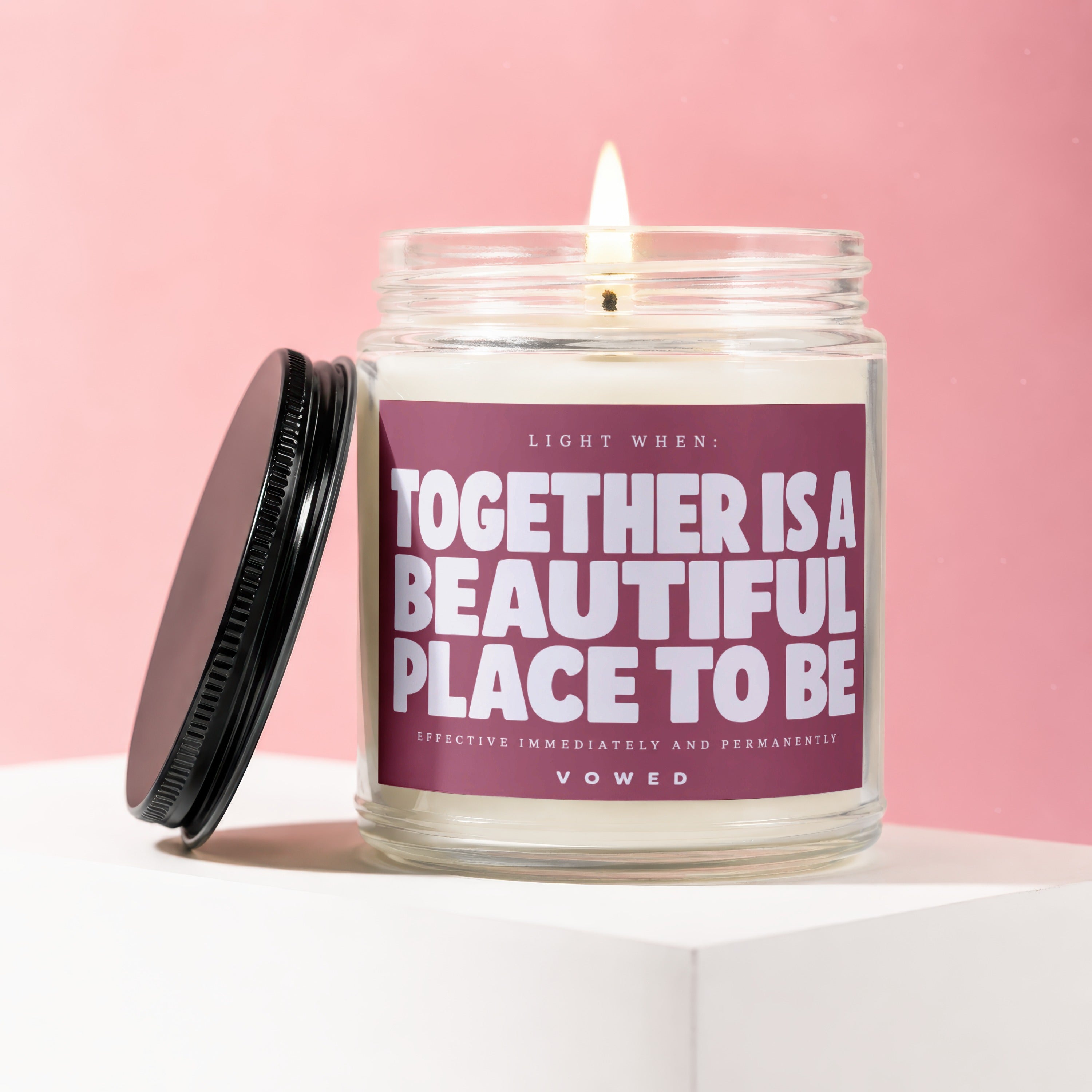 Jar candle with lid off, lit wick, and quote "Together is a beautiful place to be".