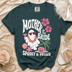 Dark teal t-shirt with "Mother of the Bride" text and a spooky ghost graphic.