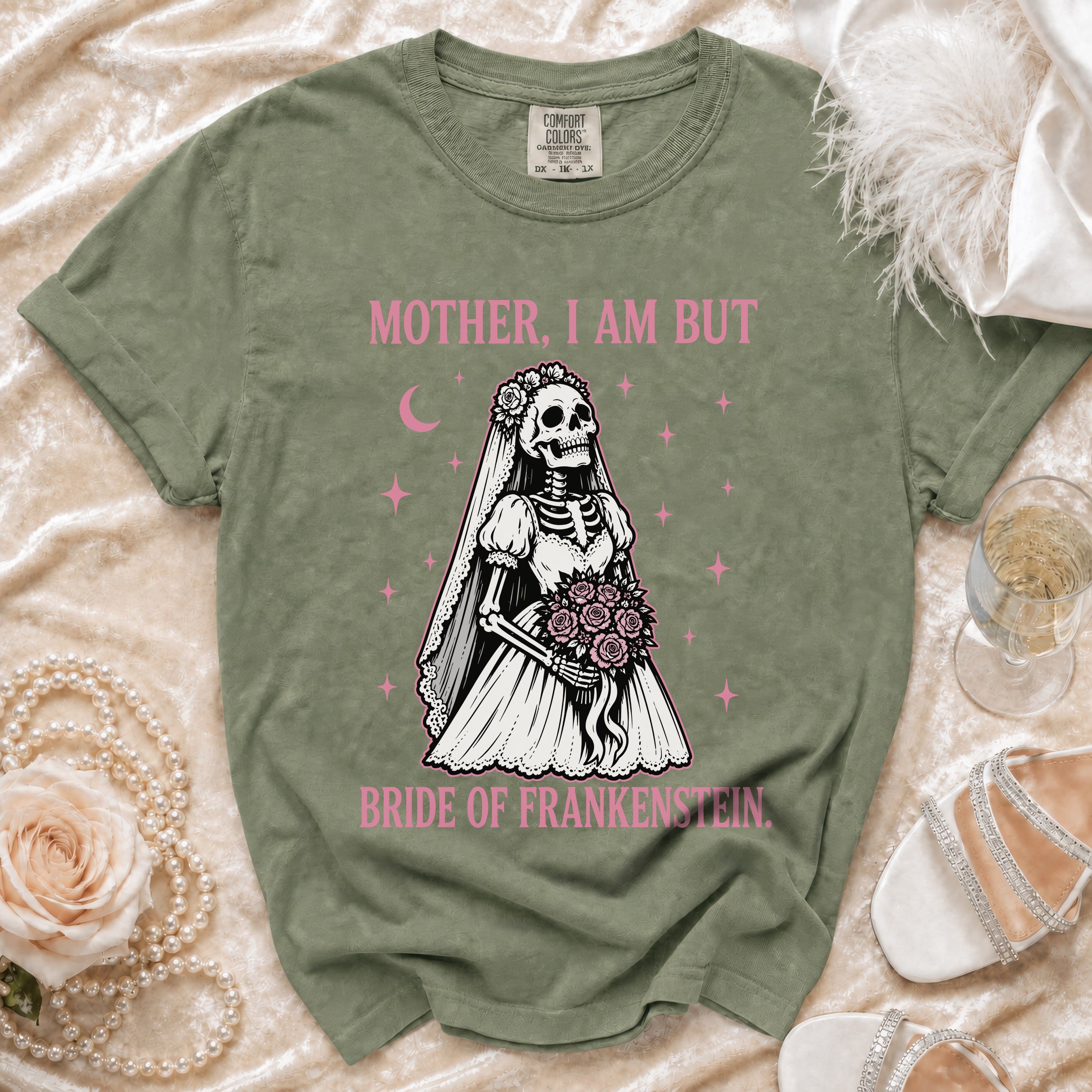 Olive green t-shirt with skeleton bride graphic and text "MOTHER, I AM BUT BRIDE OF FRANKENSTEIN."