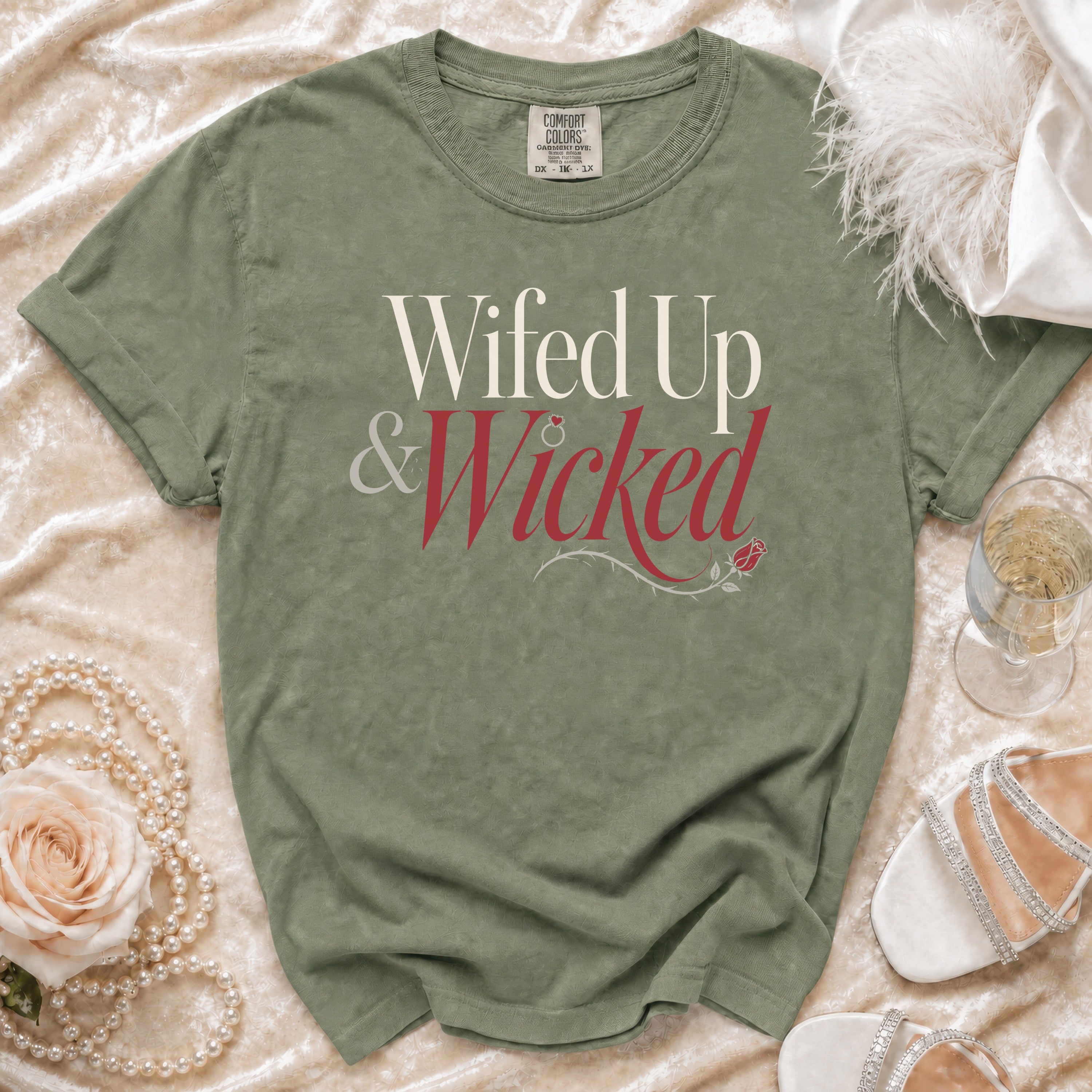 Green t-shirt with "Wifed Up & Wicked" text and rose graphic.