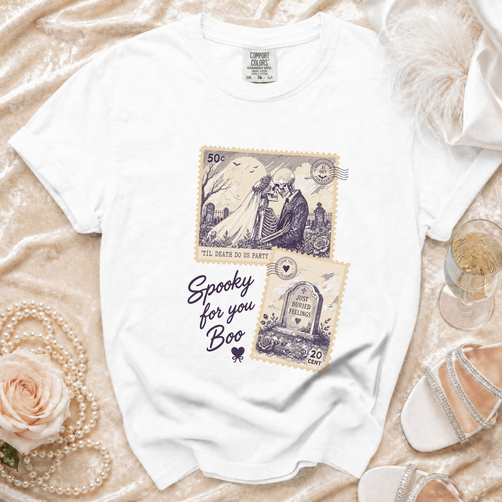 White t-shirt with spooky skeleton couple and gravestone stamp designs.