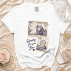 White t-shirt with spooky skeleton couple and gravestone stamp designs.