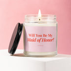 Lit candle in a jar with a pink label asking "Will You Be My Maid of Honor?".