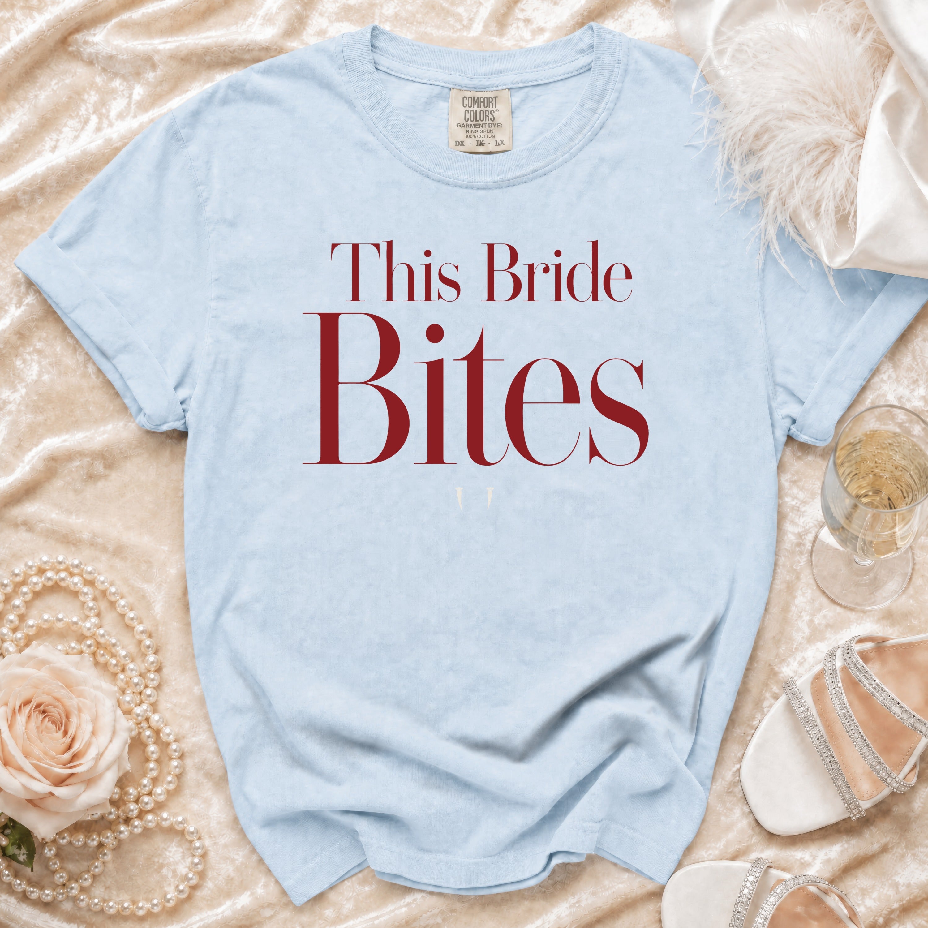 Light blue t-shirt with "This Bride Bites" text in maroon.