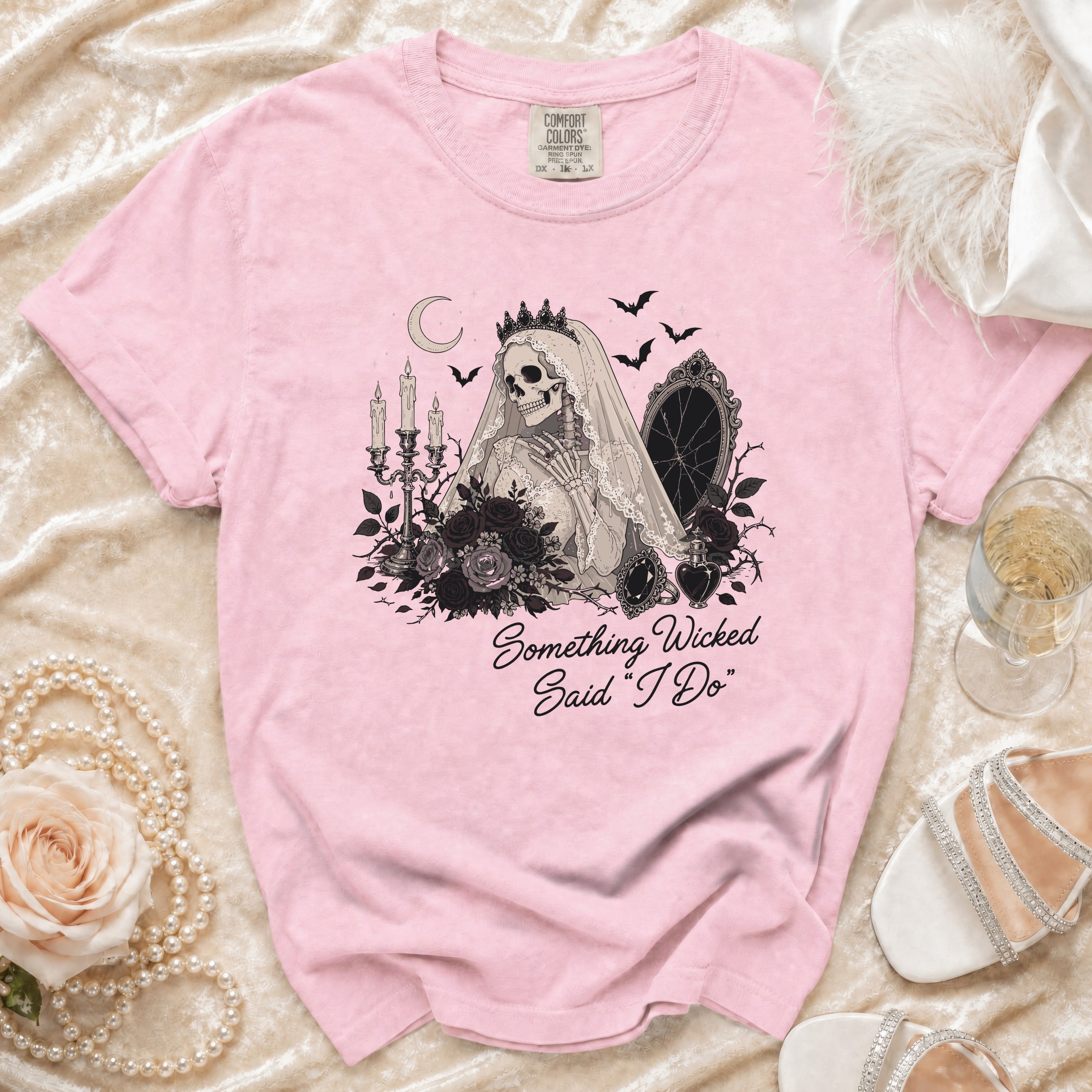 Pink t-shirt with skeleton bride graphic and "Something Wicked Said 'I Do'" text.