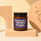 Amber jar candle with purple label reading "Bridesmaid by Invitation Oath" and smaller text.