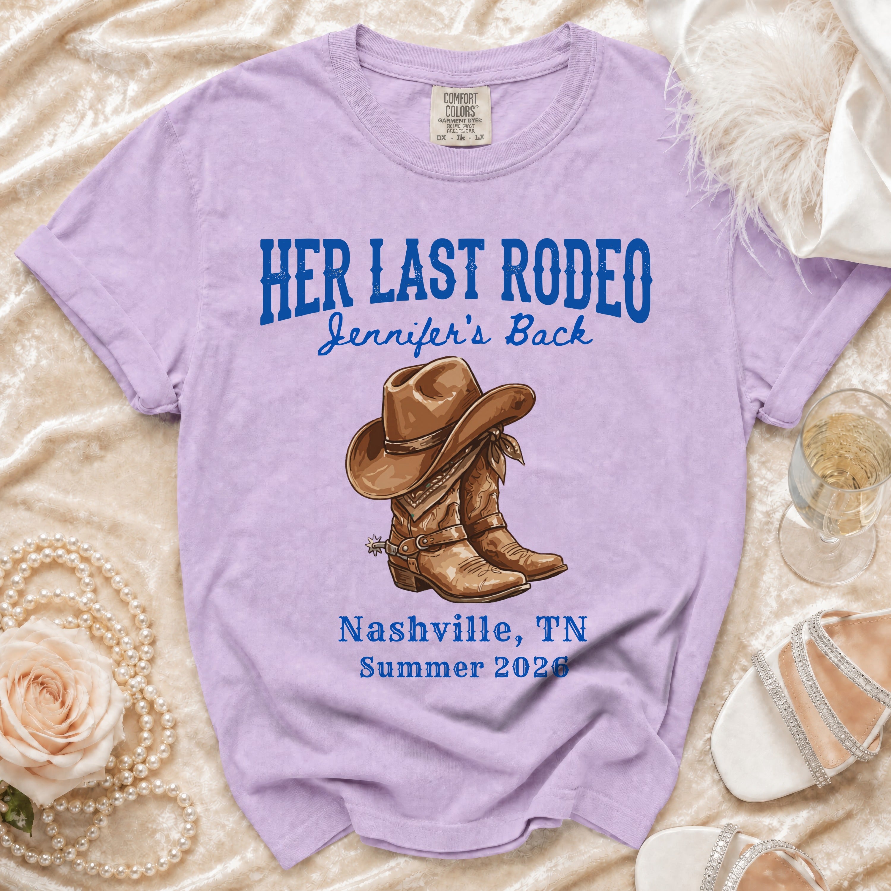 Lavender t-shirt with "Her Last Rodeo" and cowboy boots graphic.