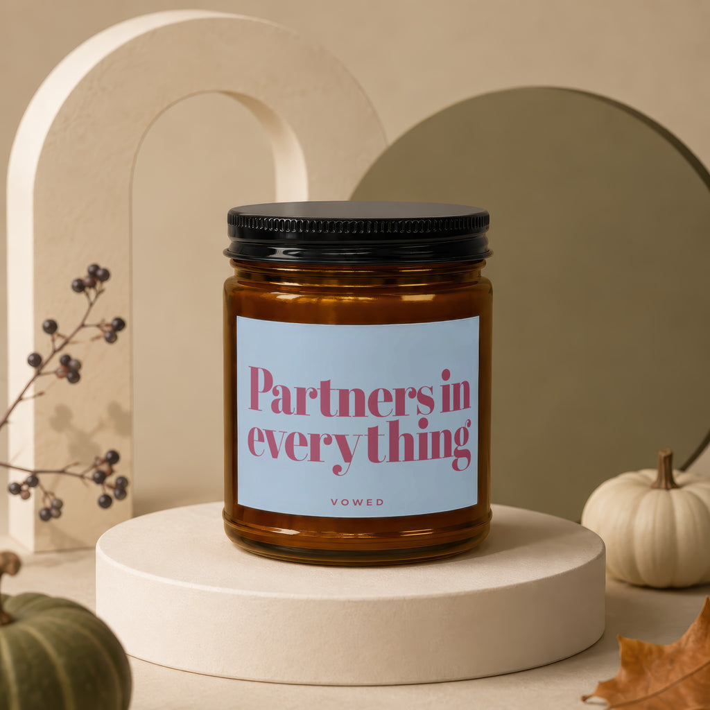 Amber candle in jar with "Partners in everything" and "vowed" text on label.