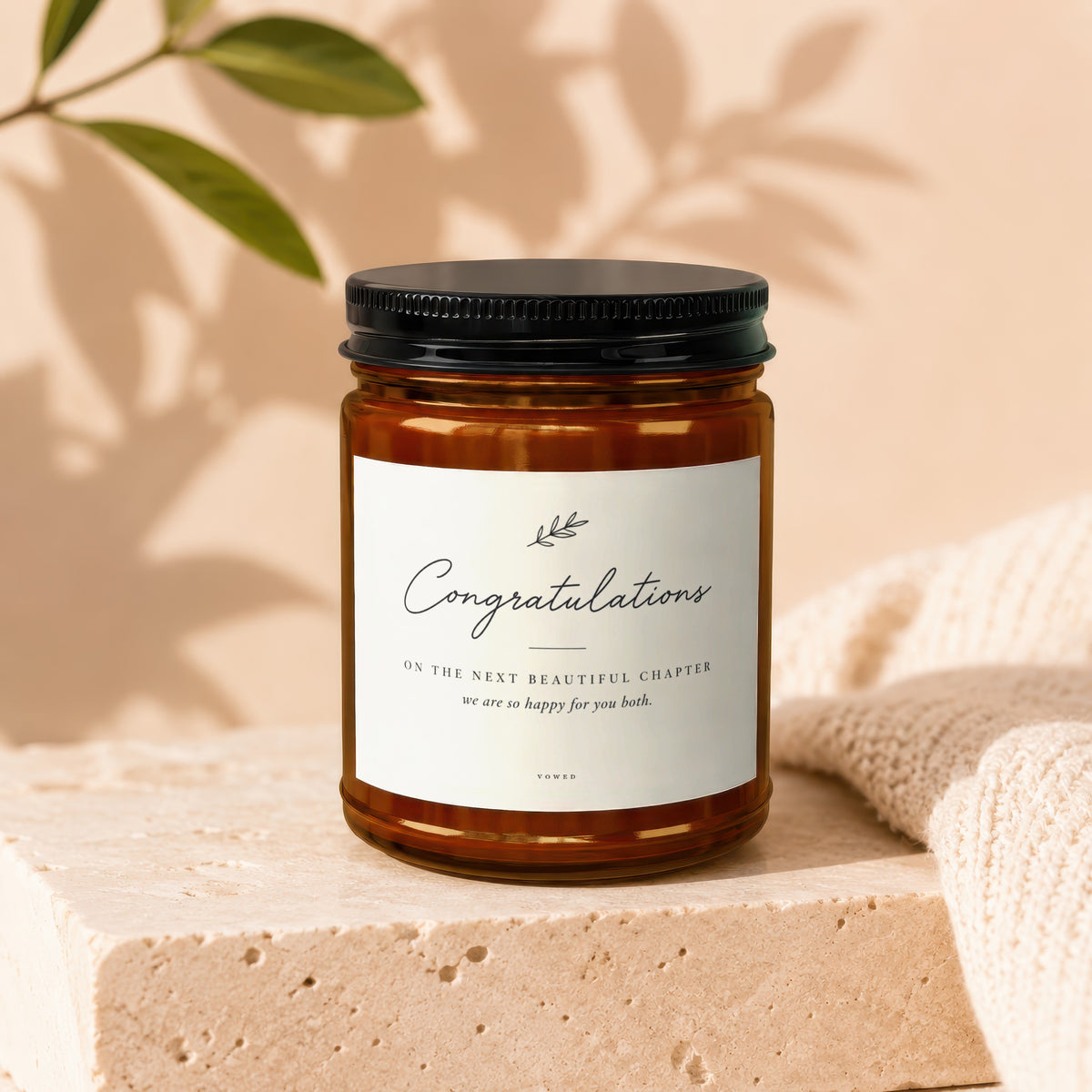 Amber jar candle with black lid, "Congratulations" text for a new chapter.