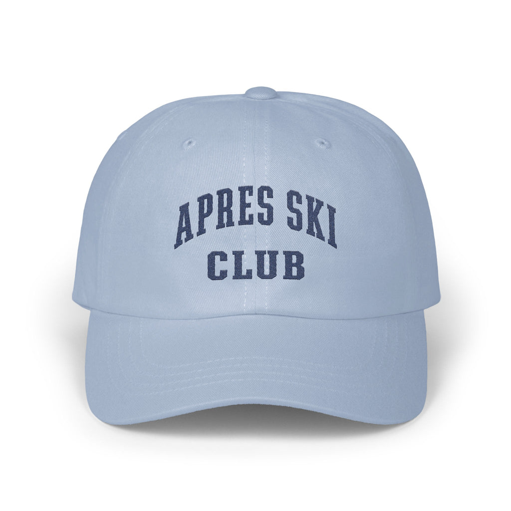 Light blue baseball cap featuring navy blue embroidered text that reads APRES SKI CLUB.