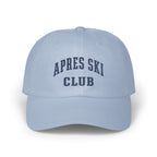 Light blue baseball cap featuring navy blue embroidered text that reads APRES SKI CLUB.