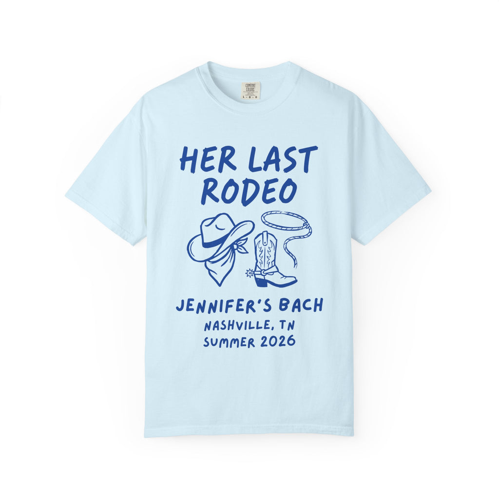 Light blue t-shirt with "Her Last Rodeo" text, cowboy hat, lasso, and boots.