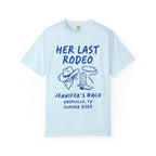 Light blue t-shirt with "Her Last Rodeo" text, cowboy hat, lasso, and boots.