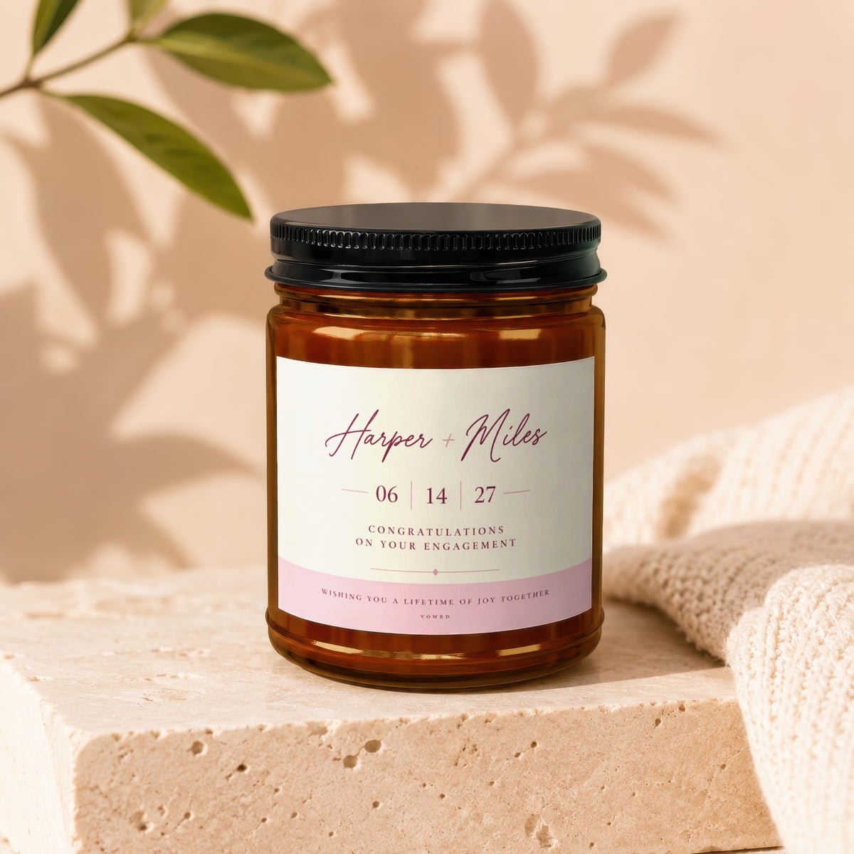 Candle with "Harper + Miles" and engagement message.