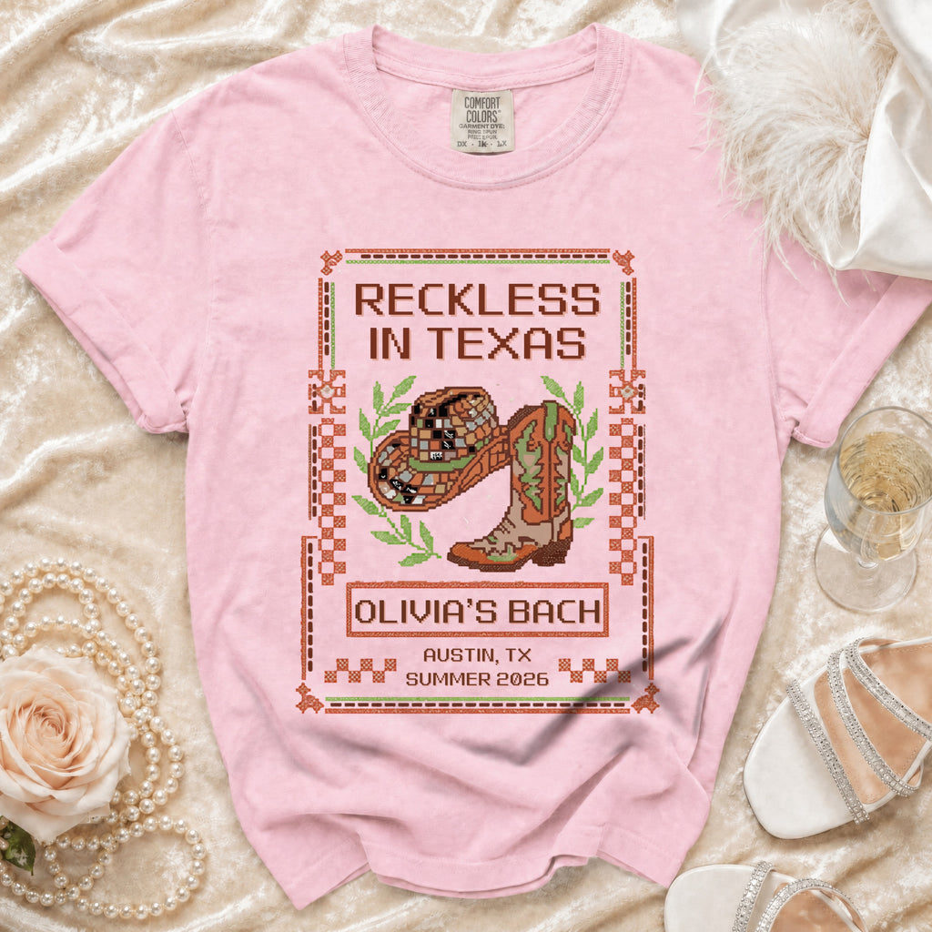 Pink t-shirt with "Reckless in Texas" and cowboy boot design for Olivia's Bach.