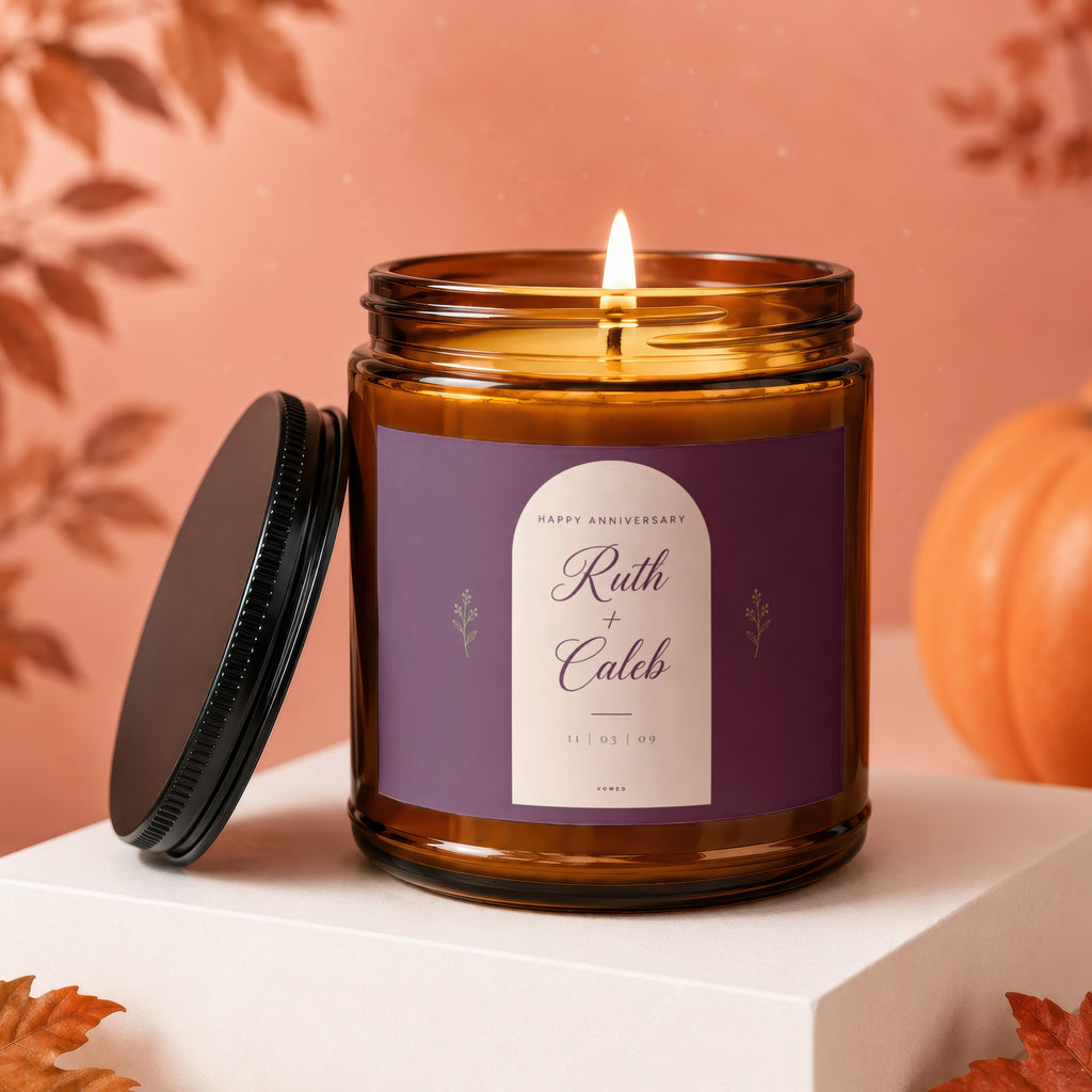 Amber jar candle lit with label "Happy Anniversary Ruth + Caleb 11 | 03 | 09".