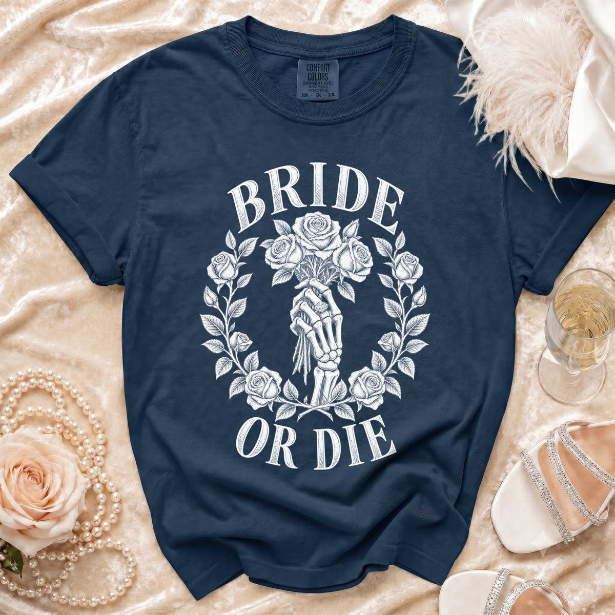 Dark navy t-shirt with white "BRIDE OR DIE" graphic featuring skeleton hand holding roses.