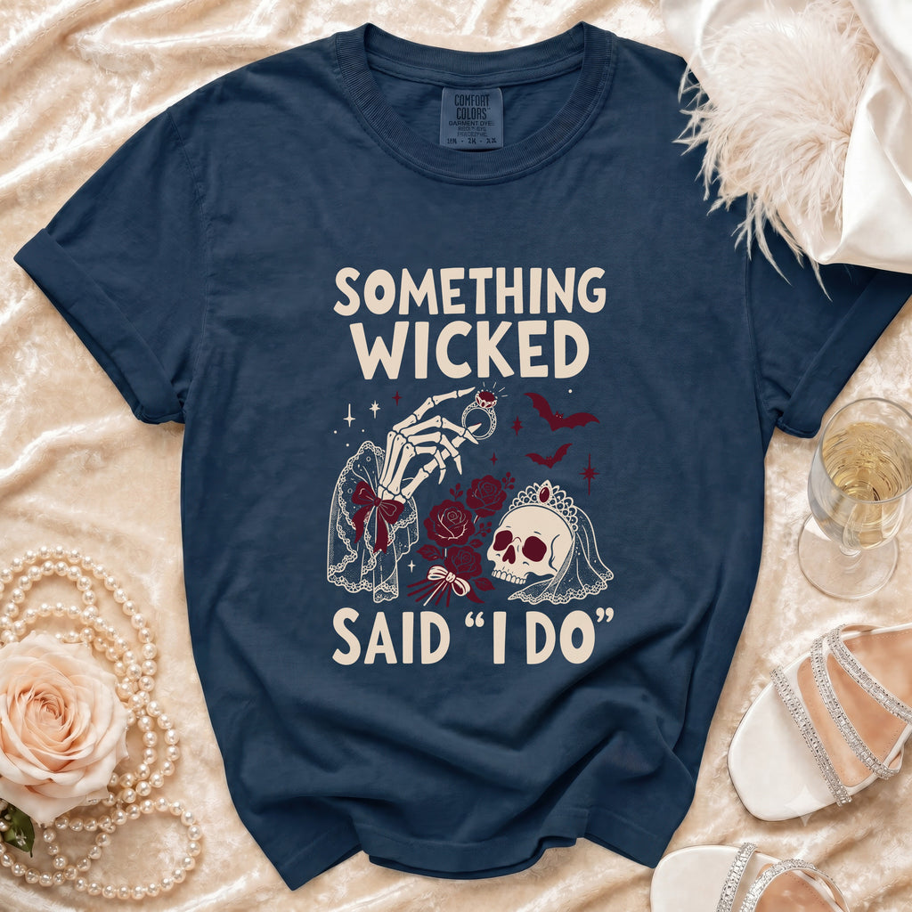 Navy t-shirt with skeleton hand, skull, roses, and text "SOMETHING WICKED SAID 'I DO'".