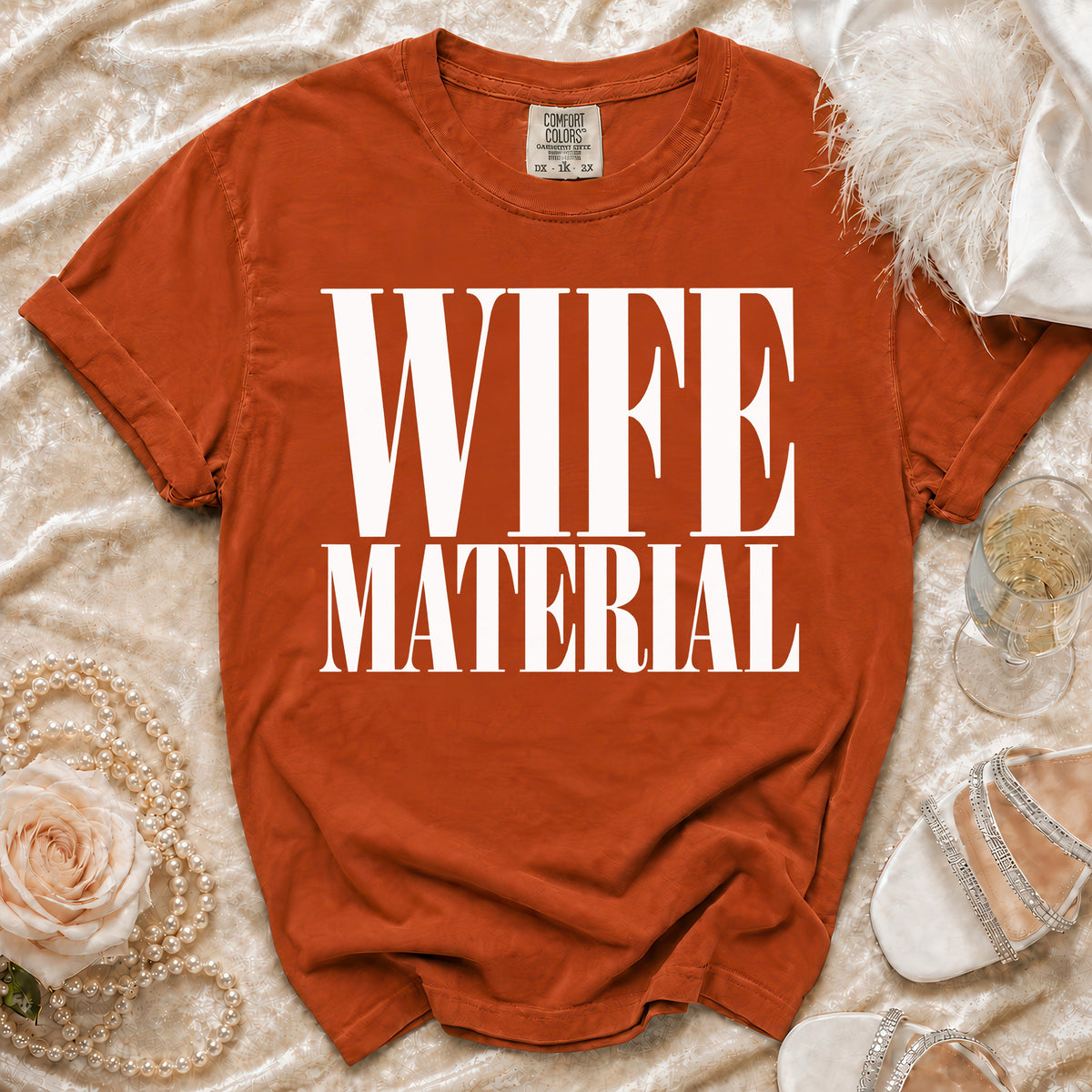 Orange t-shirt with "WIFE MATERIAL" printed in white text.