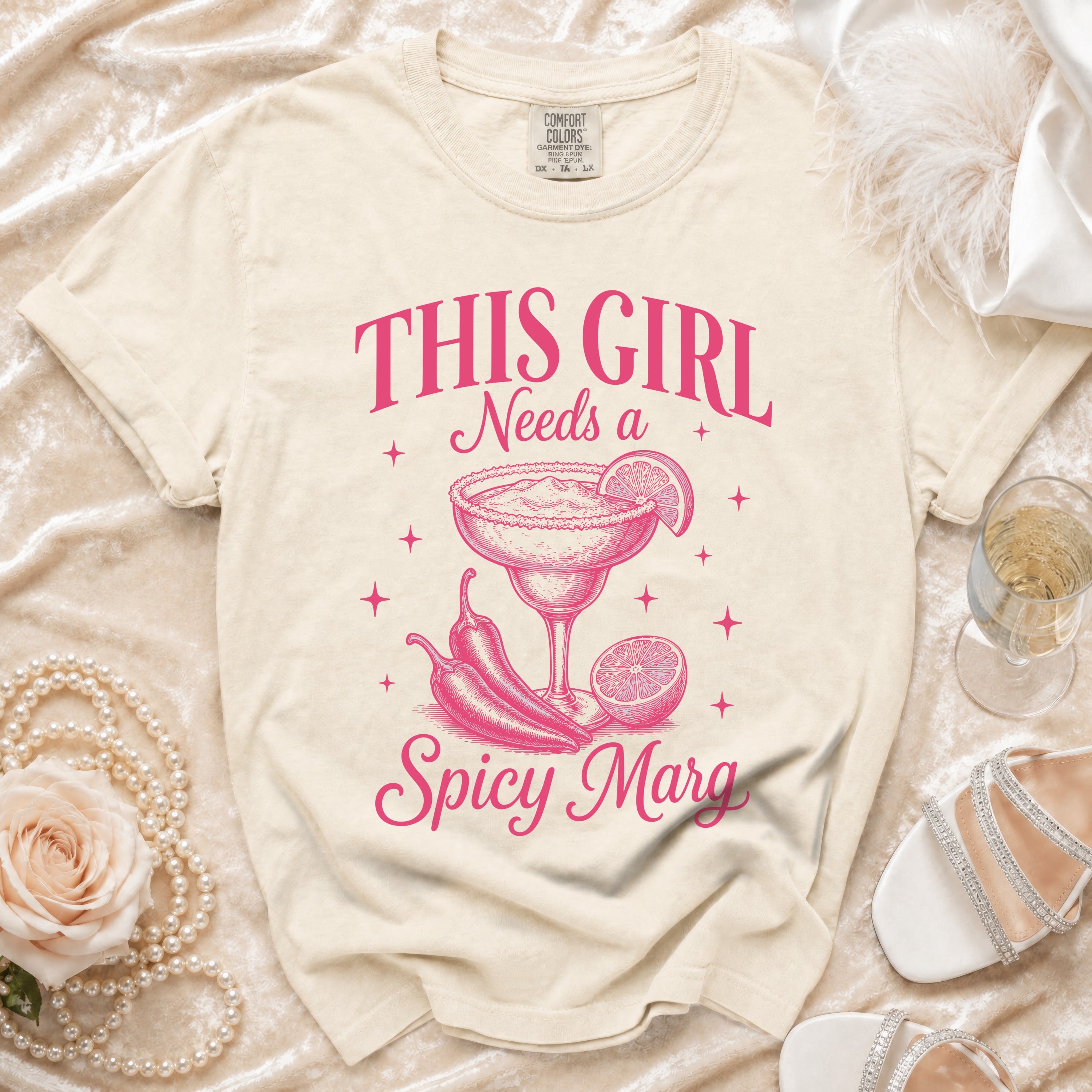 Cream t-shirt with pink text and graphics reads "THIS GIRL Needs a Spicy Marg".