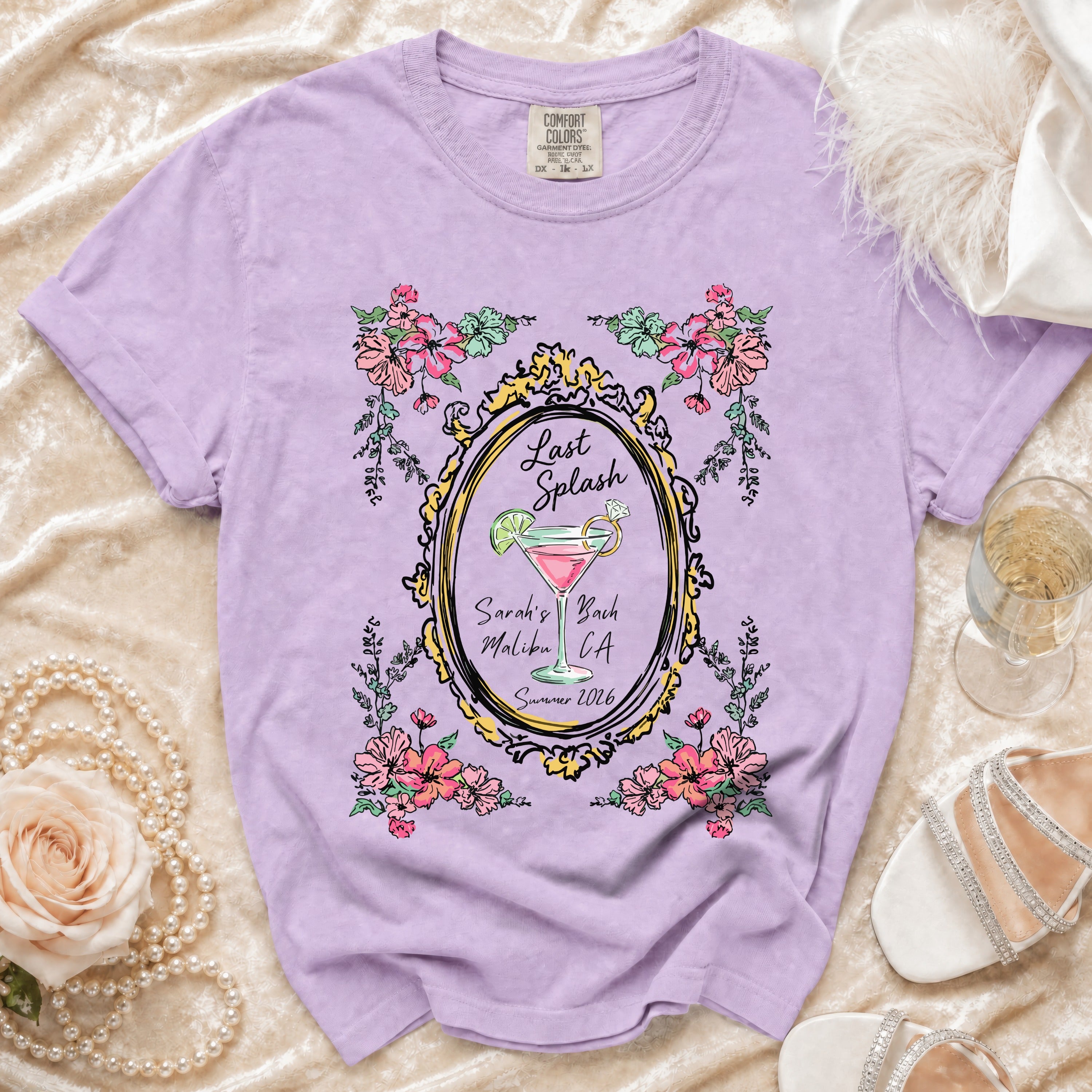 Lilac t-shirt with "Last Splash Sarah's Bach Malibu CA Summer 2026" text and floral frame.