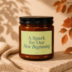 Amber candle with label "A Spark for Our New Beginning" by Vowed.