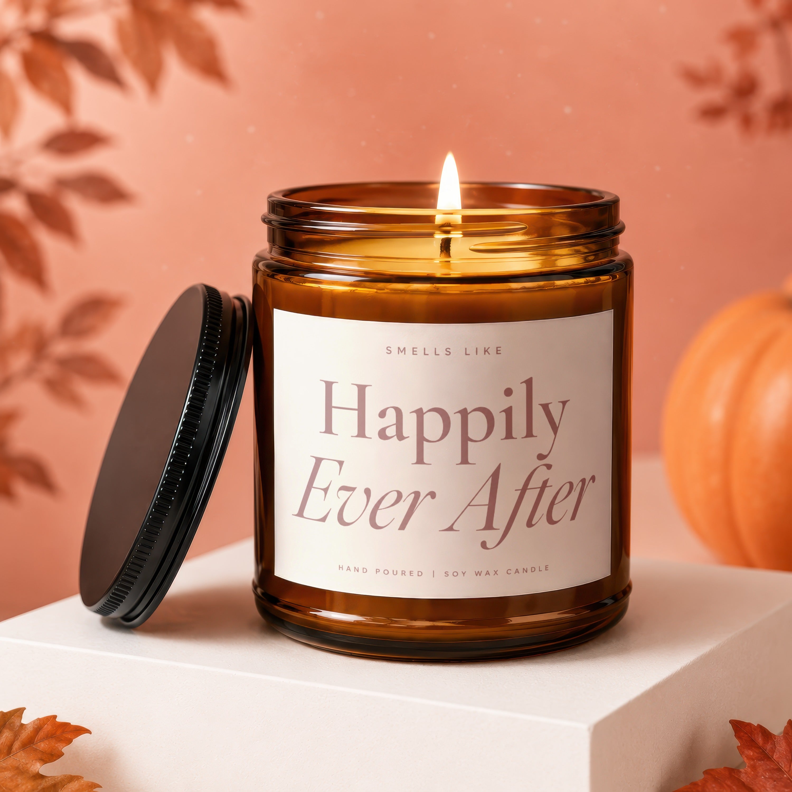 Amber jar candle with lit wick labeled "Happily Ever After," hand-poured soy wax.