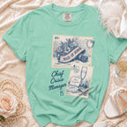 Mint green t-shirt with "Chief Crisis Manager" and "Maid of Honor" vintage stamp designs.