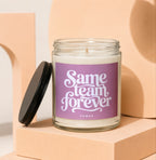 Glass candle with purple label saying "Same team forever" and "VOWED".