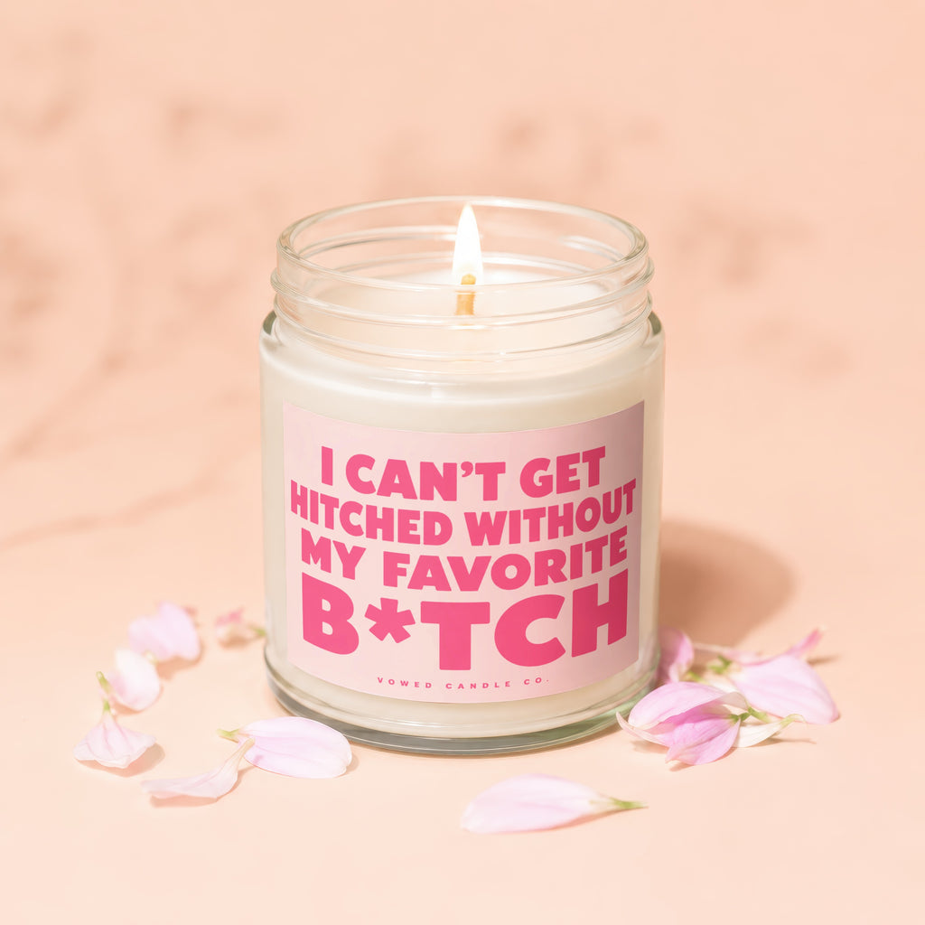 Candle with text "I CAN'T GET HITCHED WITHOUT MY FAVORITE B*TCH" surrounded by petals.