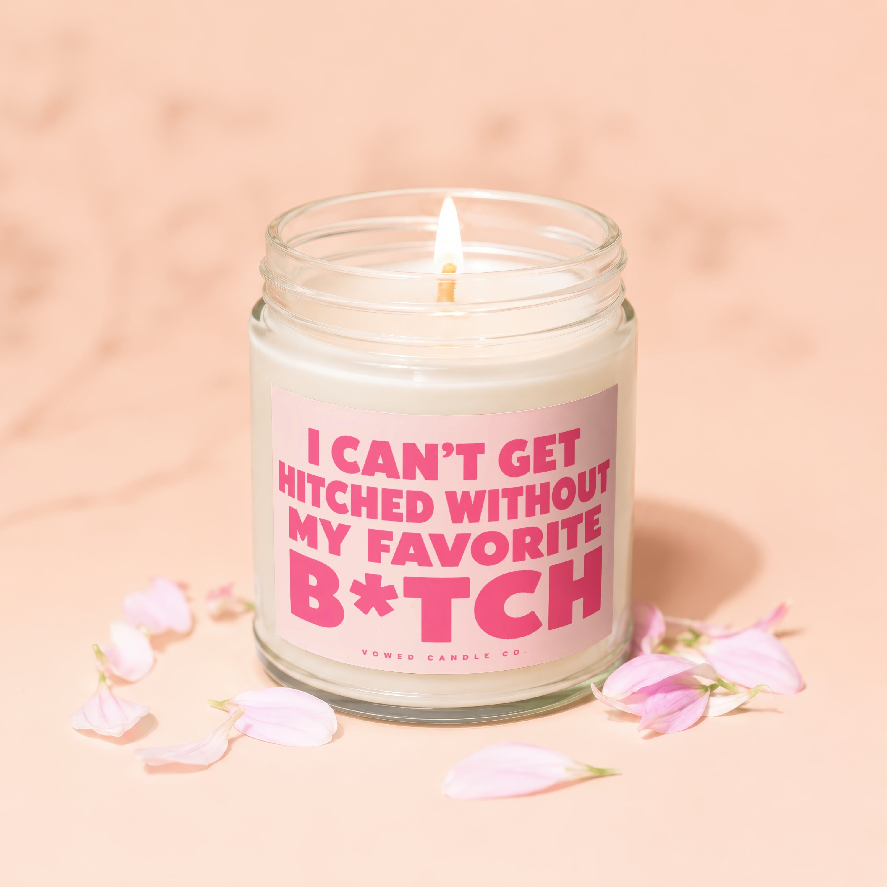 Candle with text "I CAN'T GET HITCHED WITHOUT MY FAVORITE B*TCH" surrounded by petals.