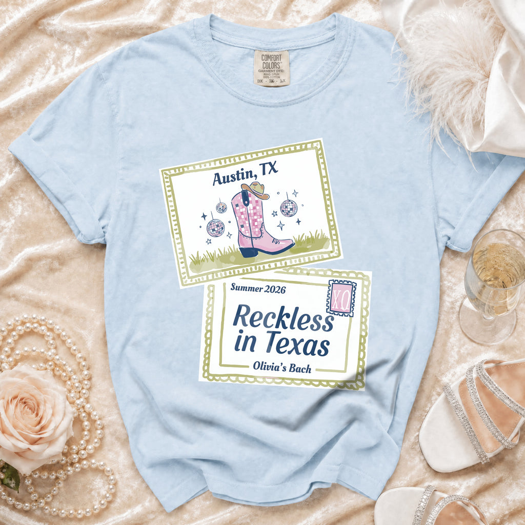 Light blue t-shirt with "Austin, TX Summer 2026 Reckless in Texas Olivia's Bach" design.