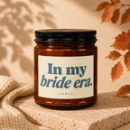 Amber candle with black lid on textured stone, reads "In my bride era."