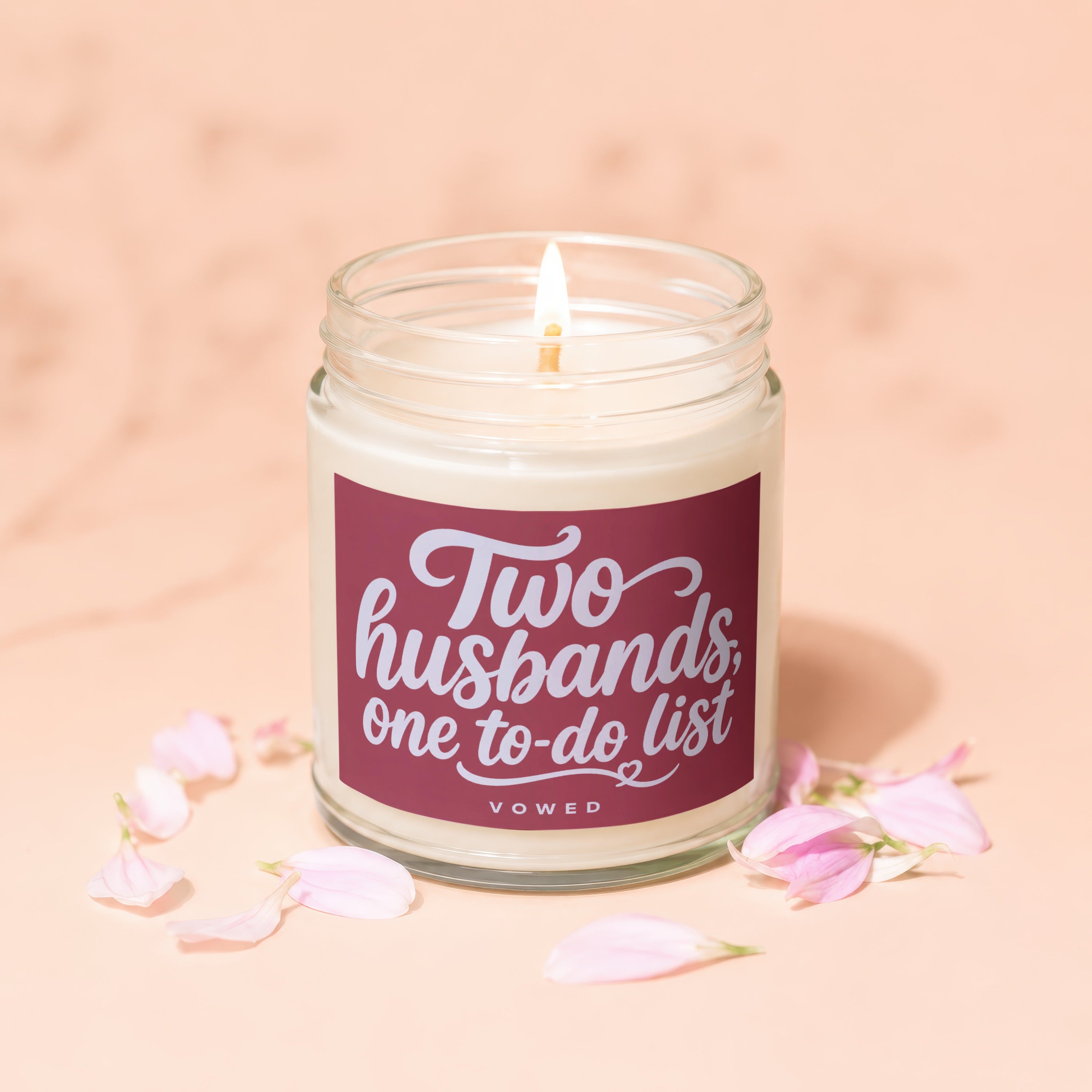 Lit candle in a jar with a label that reads "Two husbands, one to-do list".