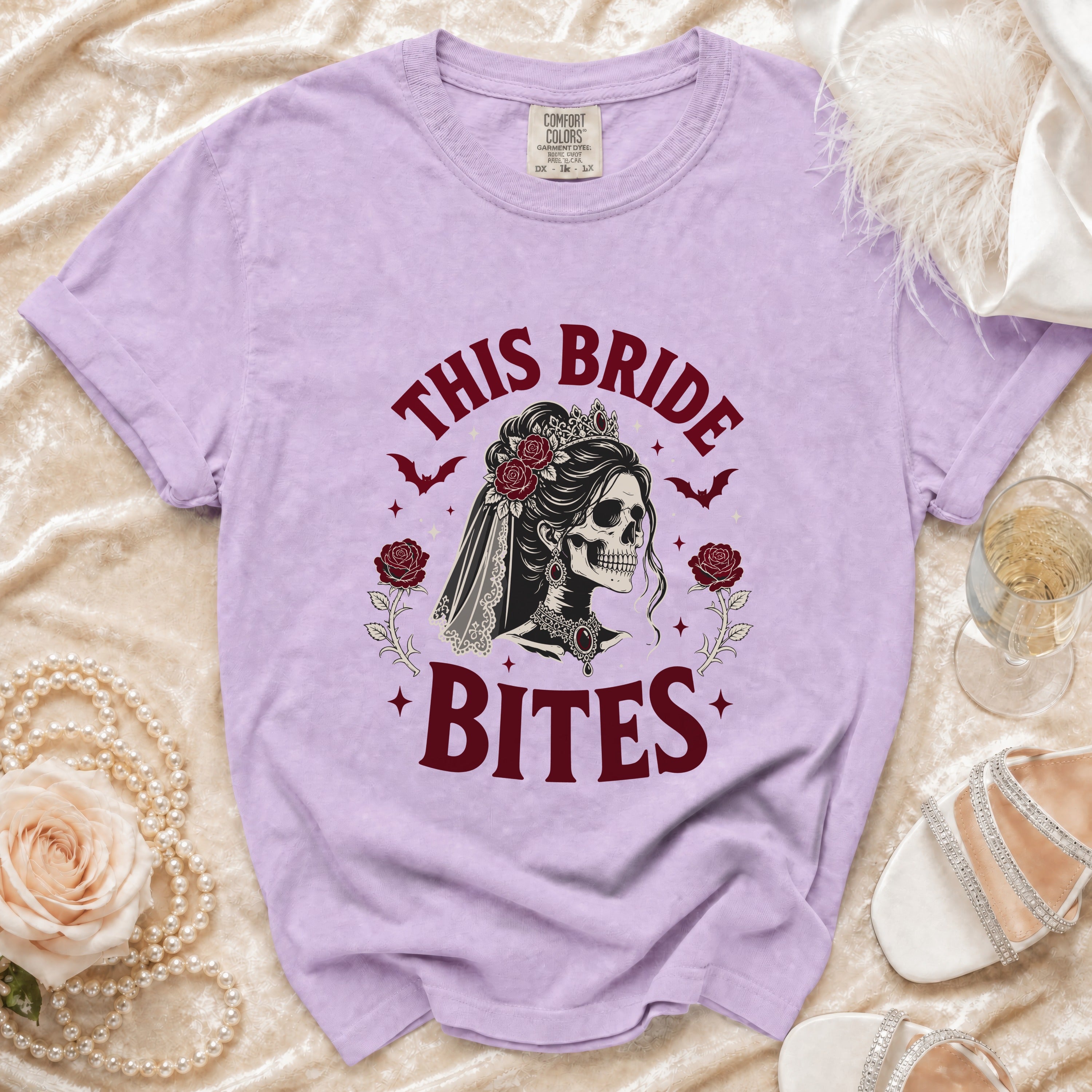 Purple t-shirt with "This Bride Bites" graphic of a skull bride and roses.