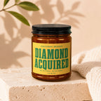 Candle with yellow label reading "Achievement unlocked diamond acquired".
