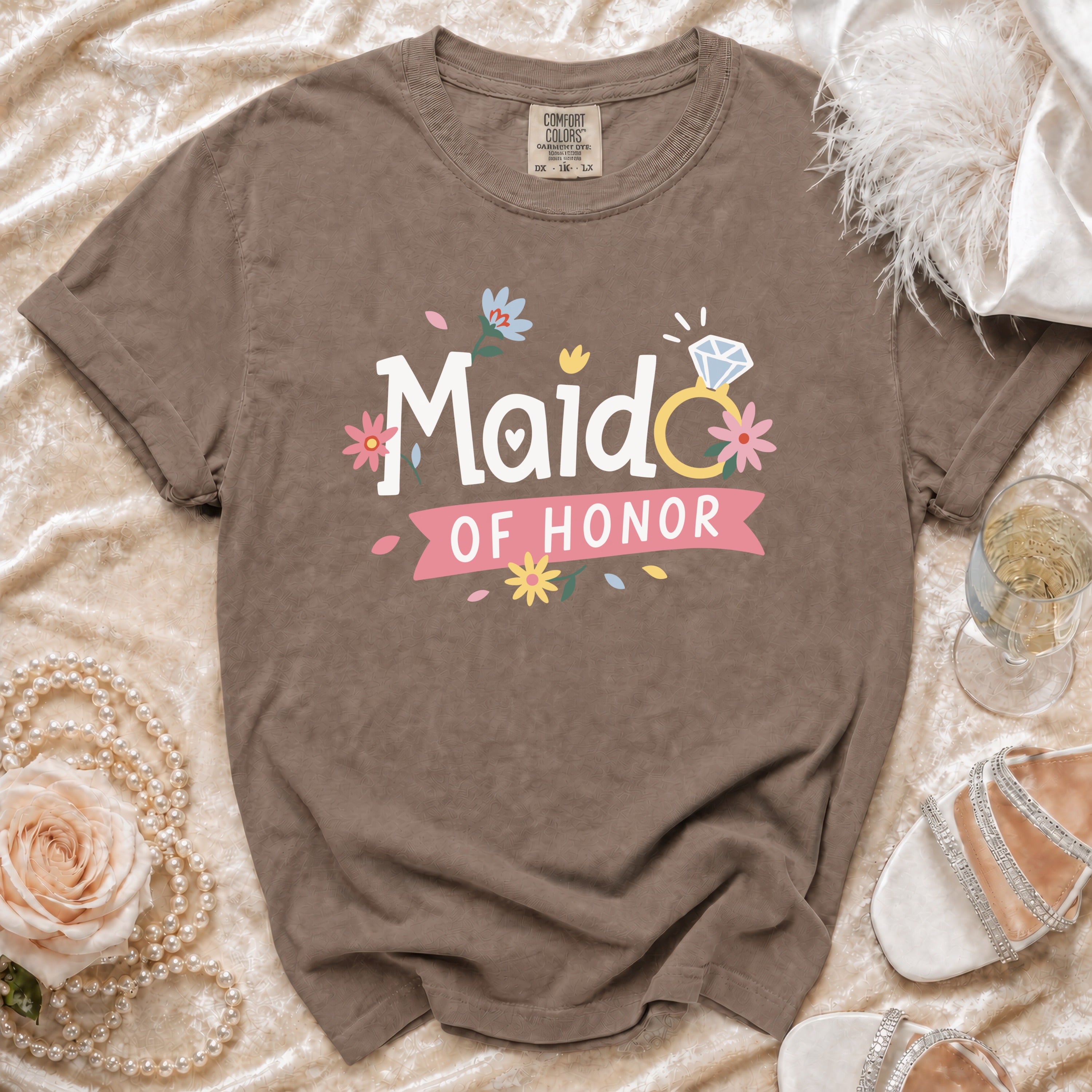 Comfort Colors brown t-shirt with "Maid of Honor" text and engagement ring graphic.