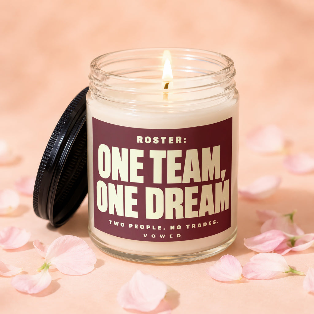 Jar candle with lit wick, black lid off, "ROSTER: ONE TEAM, ONE DREAM" text.