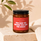 Candle with red label reading "You Said Yes Before You Saw The Dress."