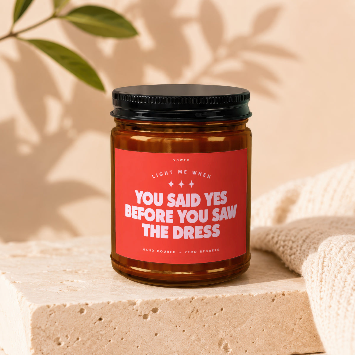 Candle with red label reading "You Said Yes Before You Saw The Dress."