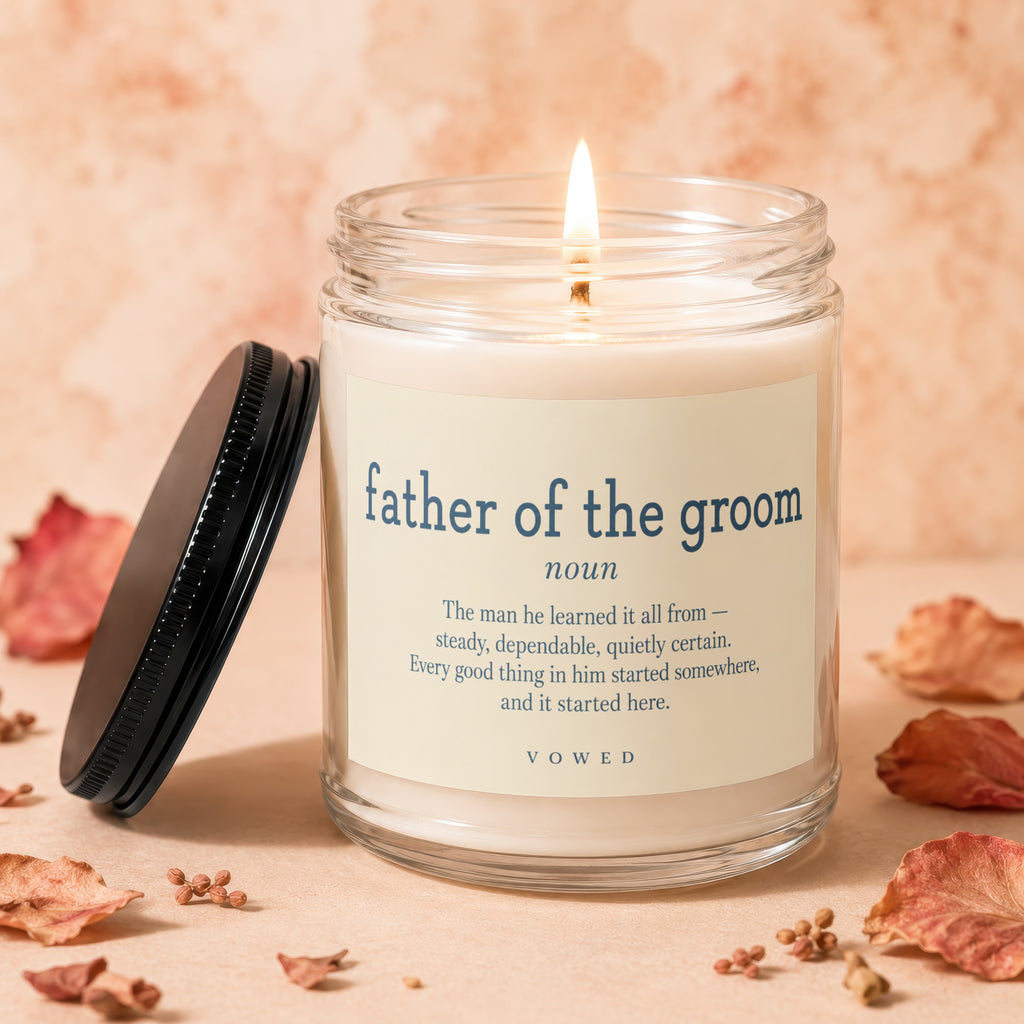 Glass candle with lit wick, featuring "father of the groom" text and definition quote.