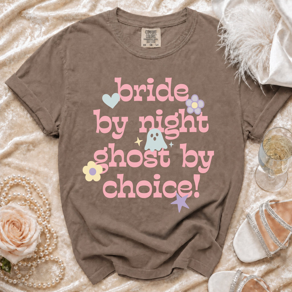 Brown t-shirt with pink text "bride by night ghost by choice" and cartoon graphics.
