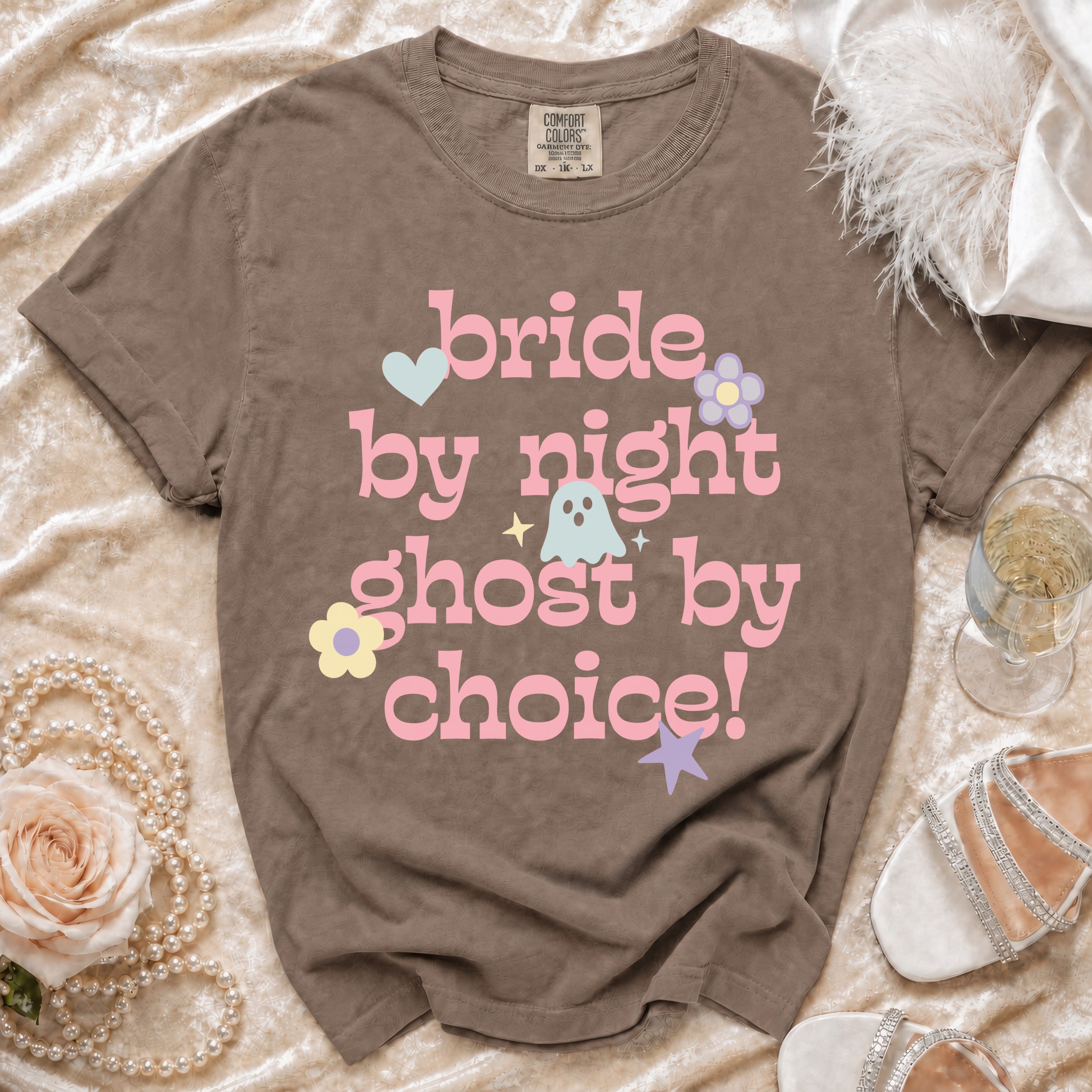Brown t-shirt with pink text "bride by night ghost by choice" and cartoon graphics.